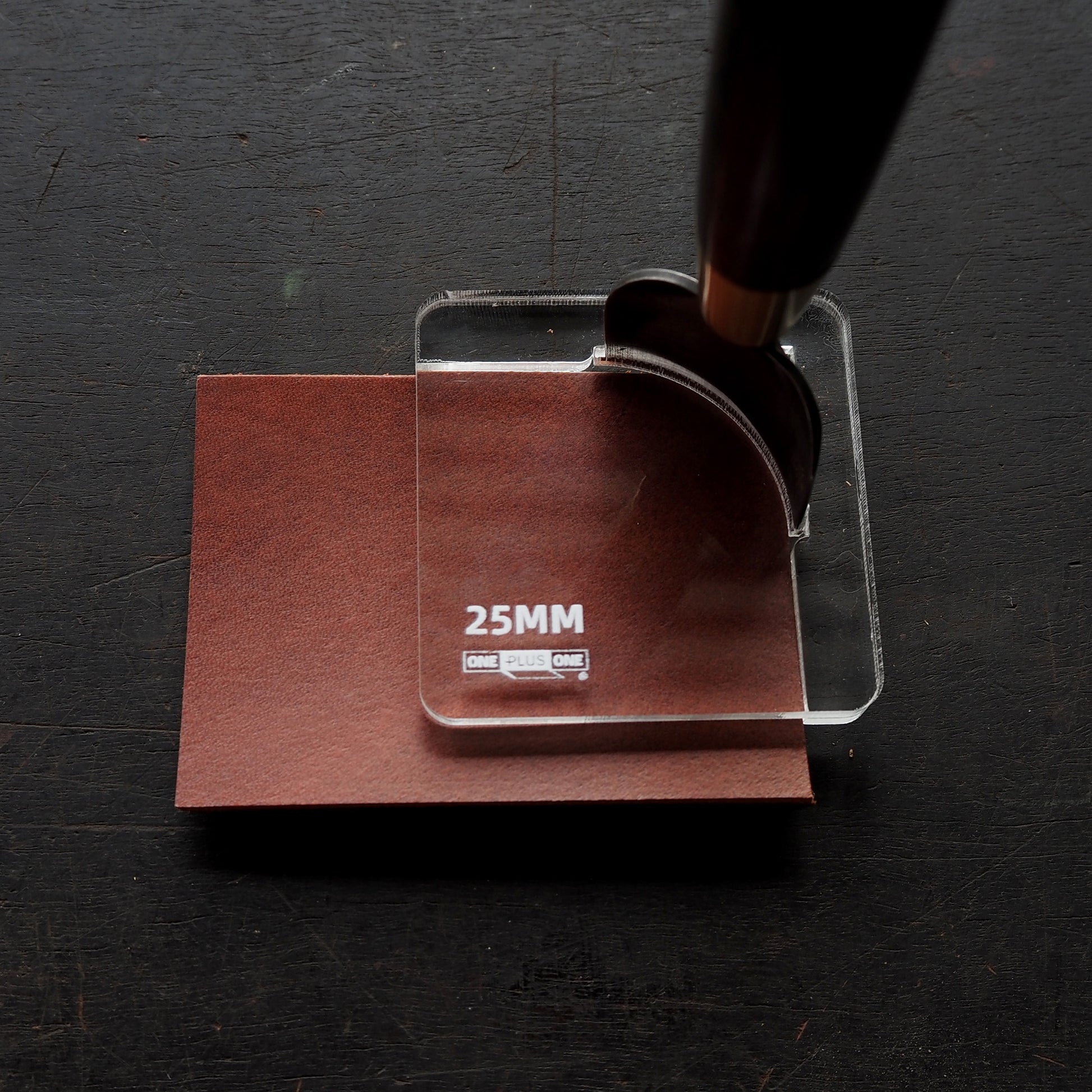 CPT-JIG-25 (Dedicated Jig for 25mm) positioned over brown material for precise corner punch cutting.