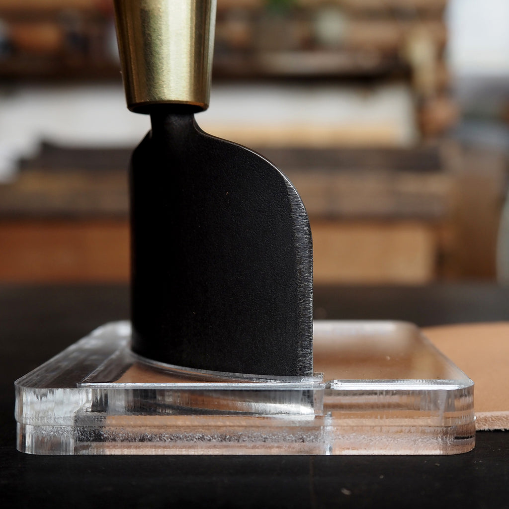 CPT-JIG-30 (Dedicated Jig for 30mm) in use with corner punch tool on a clear acrylic base.